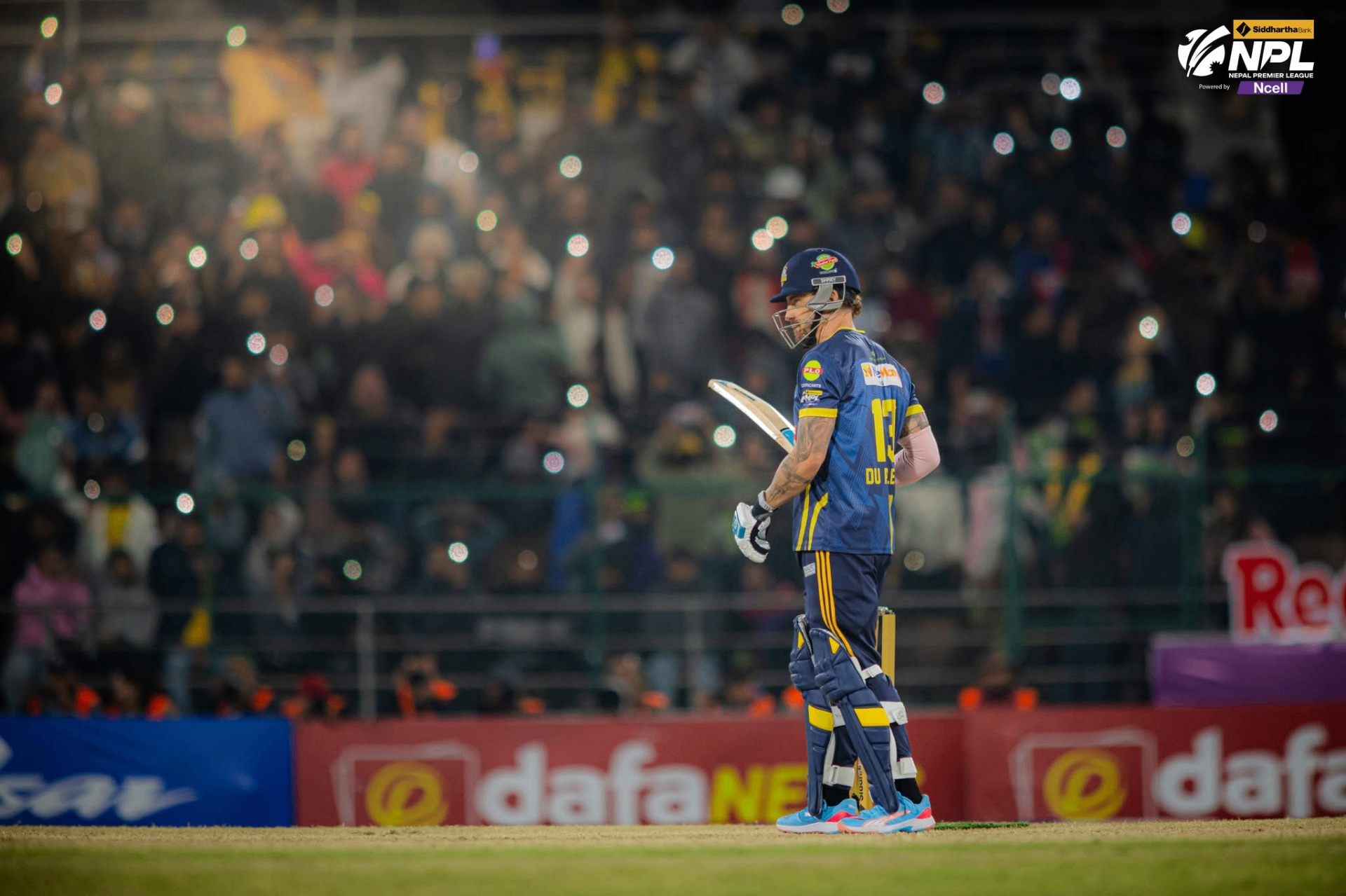 Biratnagar Kings batter walking off under stadium lights as the crowd roars